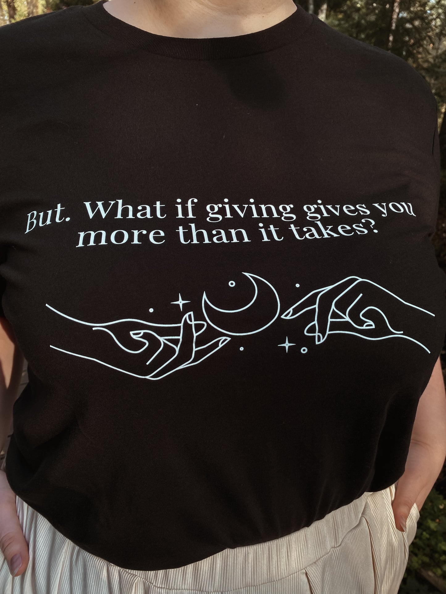 “But. What if giving gives you more than it takes?” Unisex Black T-Shirt